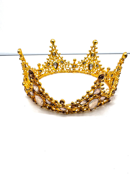 Gold crown with gemstones on a white background